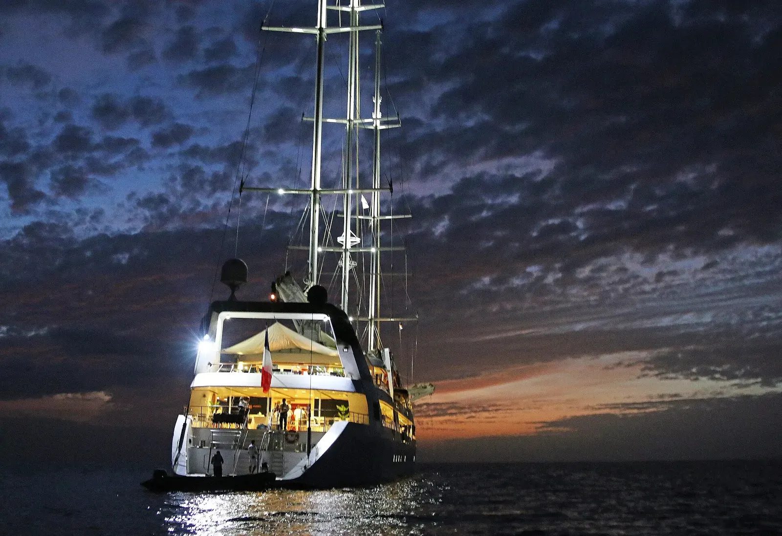 Le Ponant lit up at dusk off São Nicolau, Cape Verde