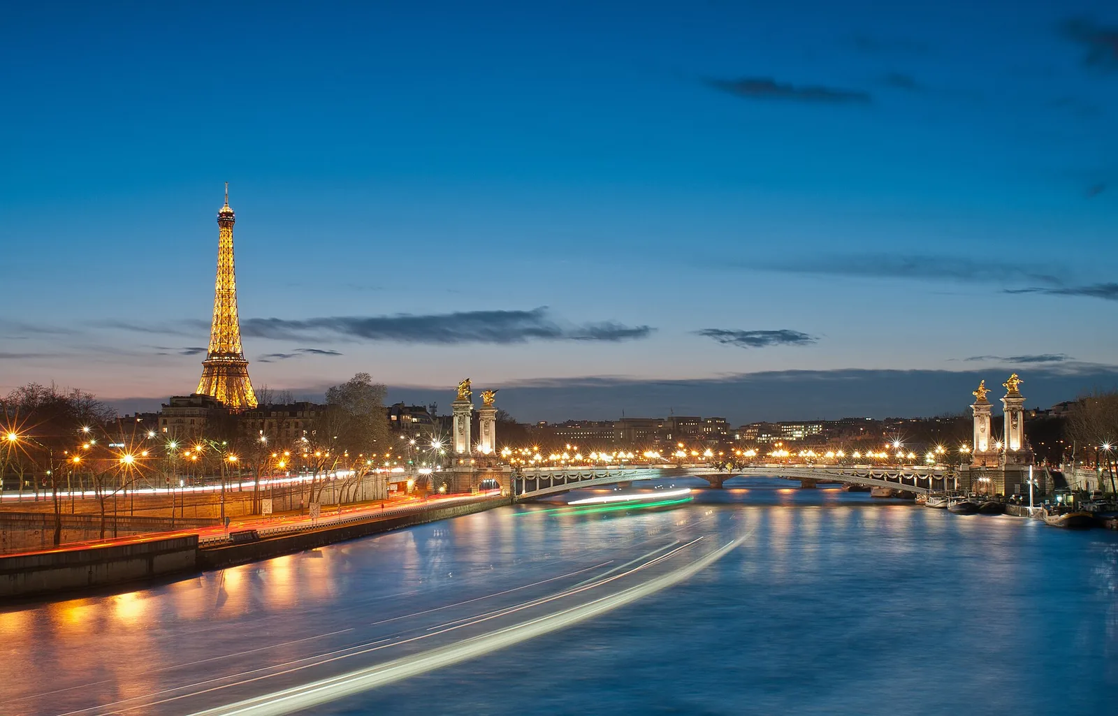 Eiffel Tower and Pont Alexandre III lit at night